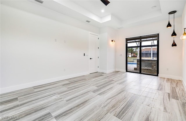 spare room featuring a tray ceiling