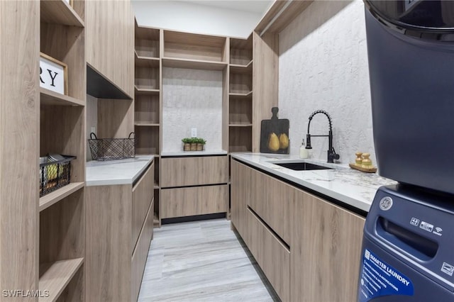 kitchen with light stone countertops and sink