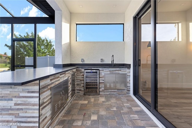 interior space featuring wine cooler and an outdoor kitchen