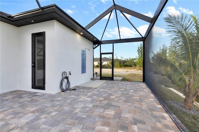 view of patio / terrace featuring glass enclosure