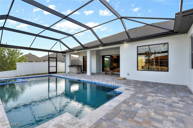 view of pool with area for grilling, a patio area, and glass enclosure