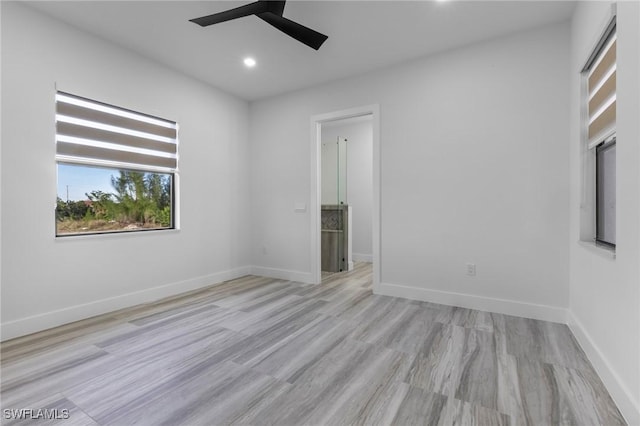 spare room featuring ceiling fan and light hardwood / wood-style flooring