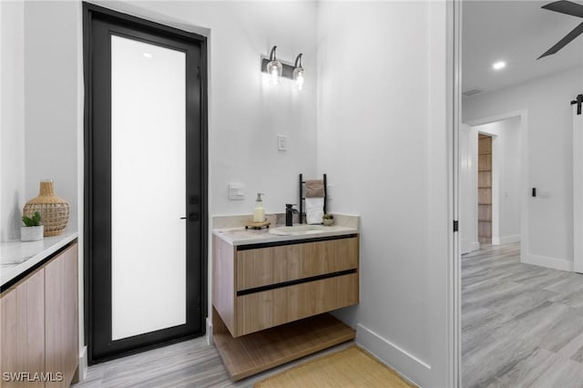 bathroom with vanity and wood-type flooring