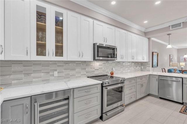 kitchen with gray cabinets, appliances with stainless steel finishes, wine cooler, hanging light fixtures, and crown molding