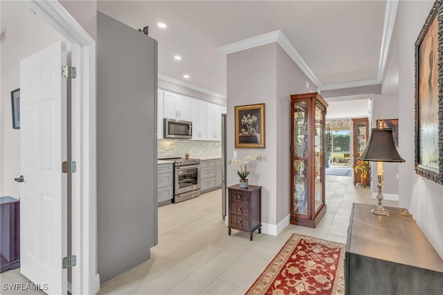 corridor featuring ornamental molding and light hardwood / wood-style floors