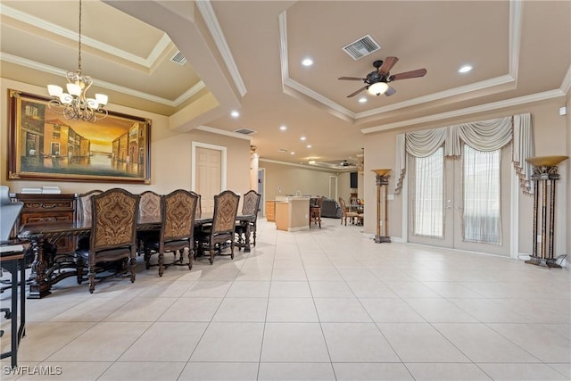 dining room with a raised ceiling, light tile patterned floors, ceiling fan with notable chandelier, and crown molding