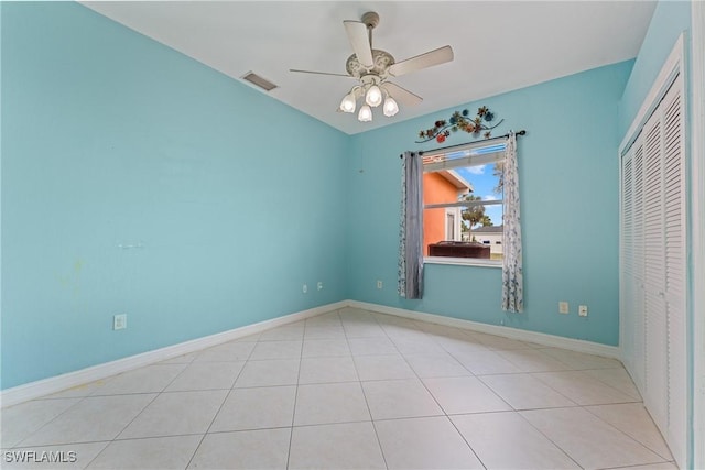 unfurnished bedroom featuring ceiling fan, light tile patterned floors, and a closet