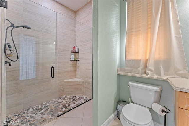 bathroom with toilet, tile patterned flooring, and an enclosed shower