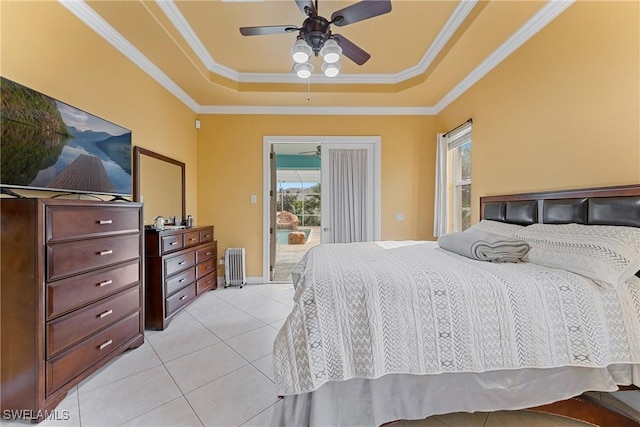 tiled bedroom with ceiling fan, access to outside, crown molding, a tray ceiling, and radiator heating unit