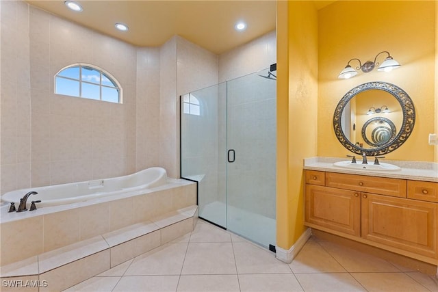 bathroom featuring independent shower and bath, tile patterned floors, and vanity