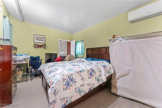 bedroom featuring a wall mounted air conditioner