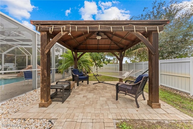 view of patio featuring a lanai, a gazebo, and a fenced in pool