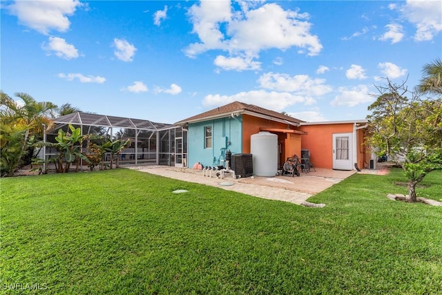 rear view of property featuring glass enclosure, central AC unit, a lawn, and a patio