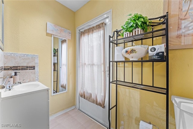 bathroom with toilet and vanity