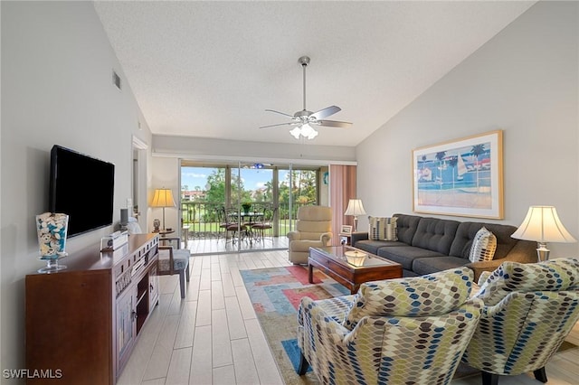 living room with vaulted ceiling, ceiling fan, a textured ceiling, and wood-type flooring