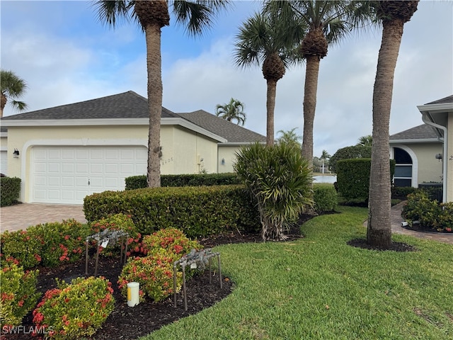 view of side of home with a garage and a lawn