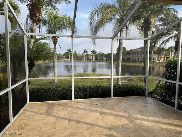 unfurnished sunroom with a water view