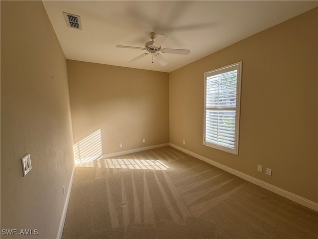 carpeted empty room featuring ceiling fan