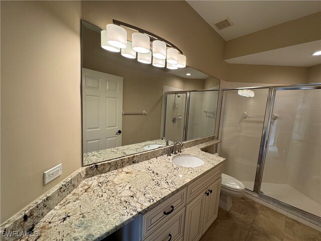 bathroom featuring toilet, vanity, and walk in shower