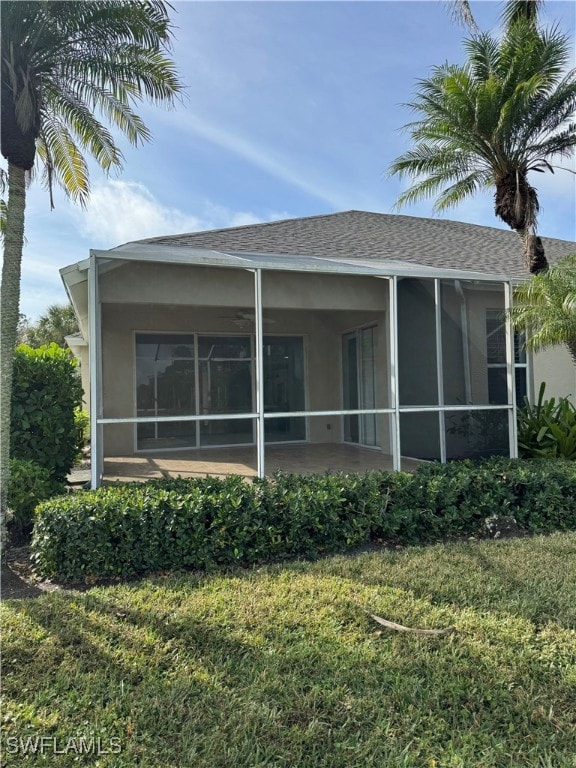 rear view of property with a yard