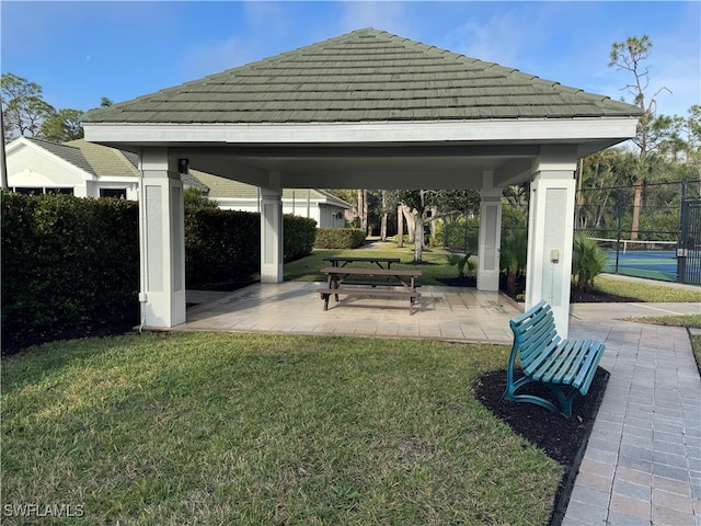 surrounding community with a gazebo, a yard, and tennis court