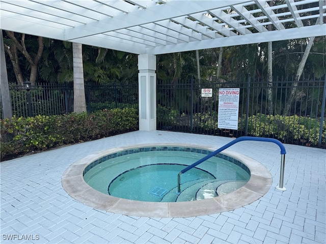 view of swimming pool with a hot tub and a pergola