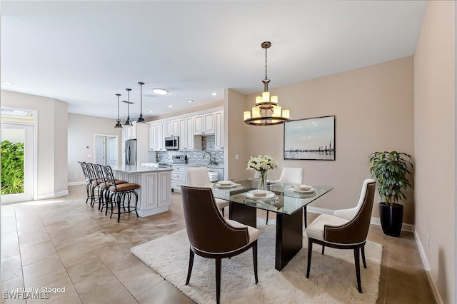 dining area featuring light tile patterned flooring and sink