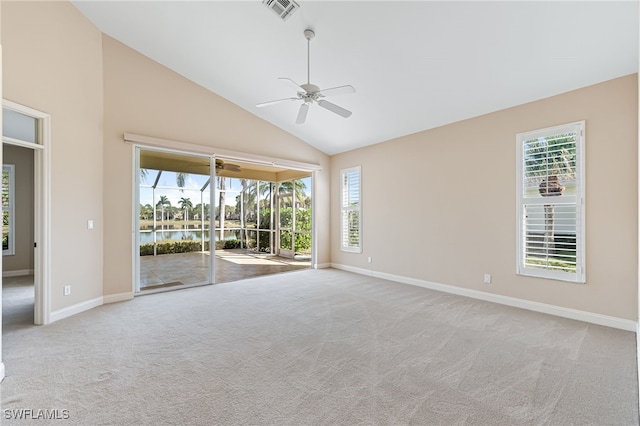 empty room featuring a water view, light colored carpet, ceiling fan, and high vaulted ceiling