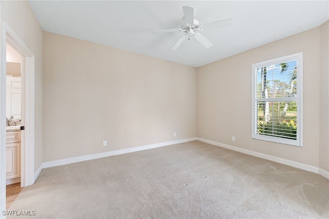 carpeted empty room with ceiling fan