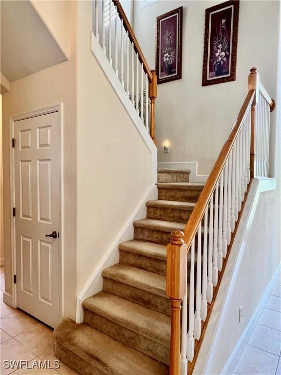 stairs with tile patterned floors