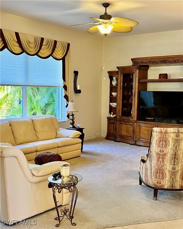 living room with ceiling fan and light colored carpet