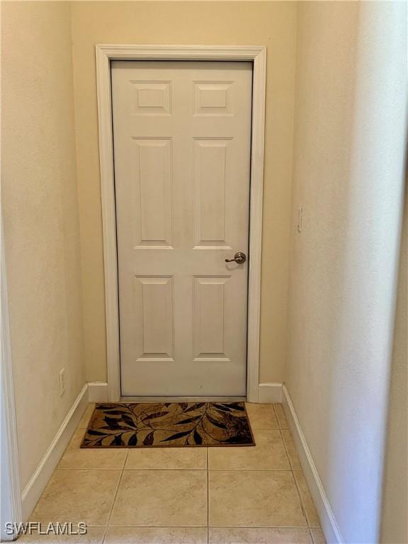 doorway with light tile patterned floors