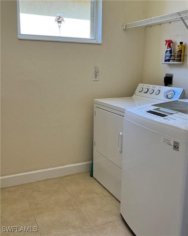 washroom with washer and dryer and light tile patterned flooring