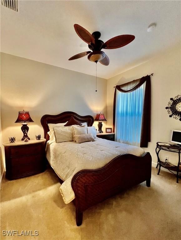 bedroom with ceiling fan and light colored carpet