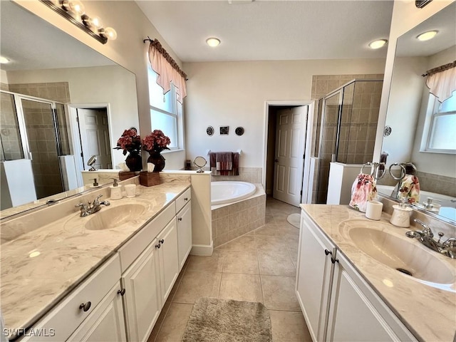 bathroom featuring tile patterned floors, vanity, and shower with separate bathtub