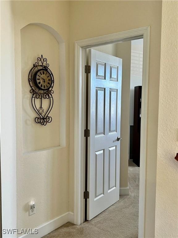 corridor with light colored carpet