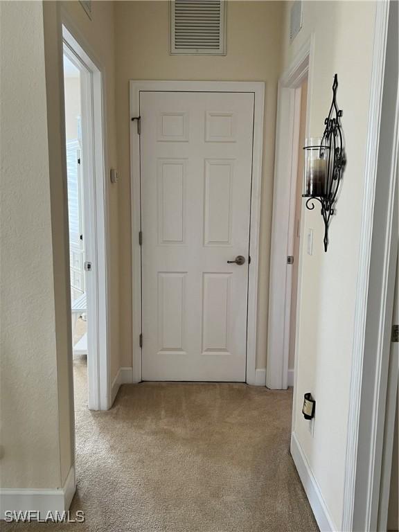 corridor with light colored carpet