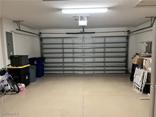 garage featuring electric panel and a garage door opener