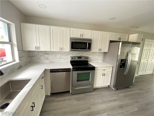 kitchen featuring plenty of natural light, sink, white cabinets, and stainless steel appliances