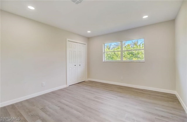 unfurnished room with light hardwood / wood-style floors