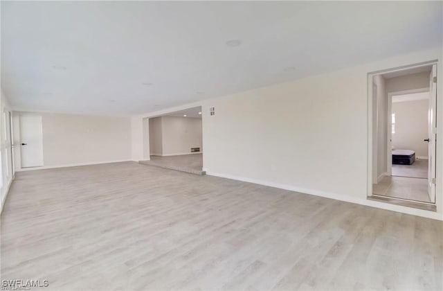 empty room with light hardwood / wood-style floors