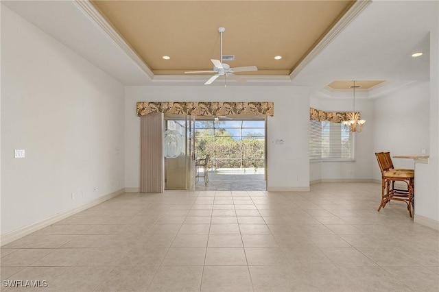 unfurnished room with ornamental molding, a raised ceiling, and ceiling fan with notable chandelier