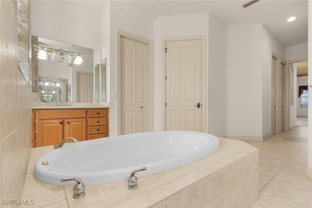 full bath featuring a garden tub, tile patterned flooring, visible vents, and a closet