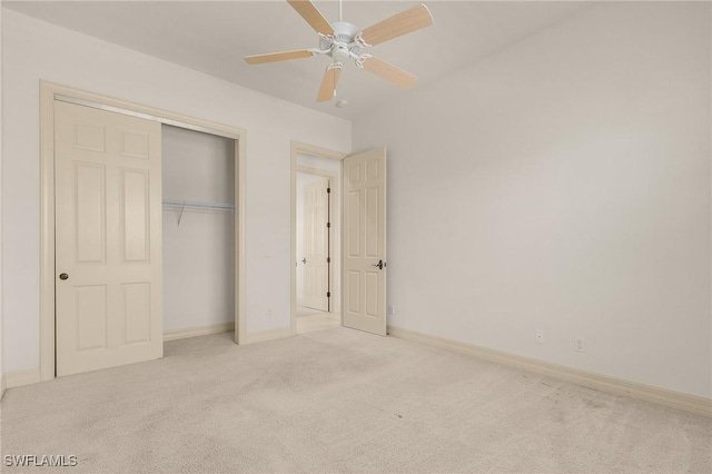 unfurnished bedroom featuring carpet floors, a closet, ceiling fan, and baseboards