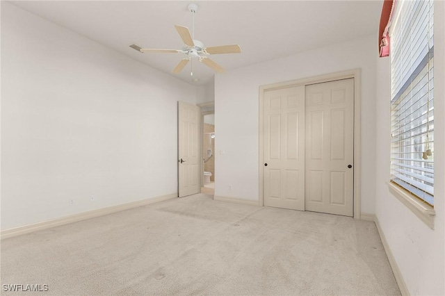 unfurnished bedroom featuring ceiling fan, carpet floors, a closet, and baseboards