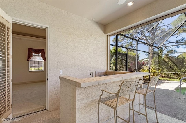 exterior space with a lanai and outdoor dry bar