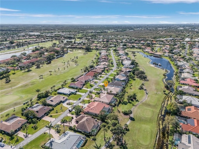 aerial view with golf course view, a water view, and a residential view