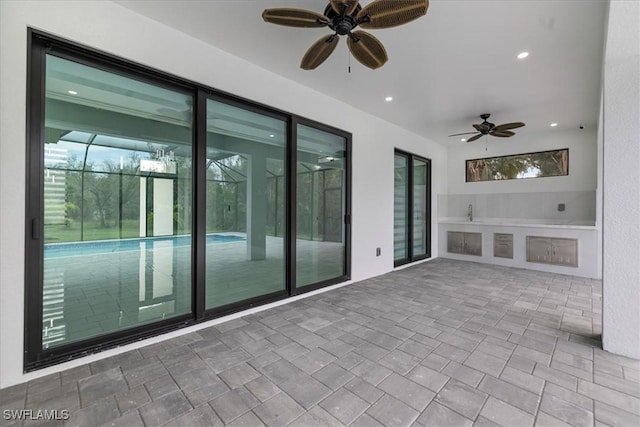 view of patio featuring ceiling fan