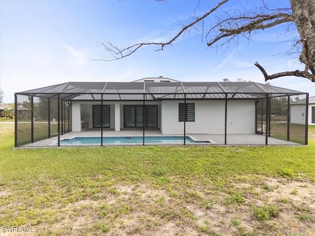 rear view of house with a patio area, a lanai, and a lawn