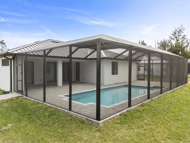 view of swimming pool featuring a lanai, a yard, and a patio